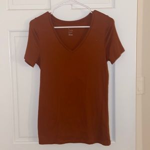Orange V-neck t-shirt.